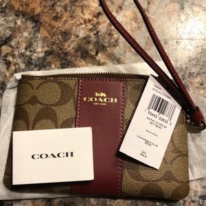 Small COACH wristlet bag. Brand new. Khaki/ cherry color.